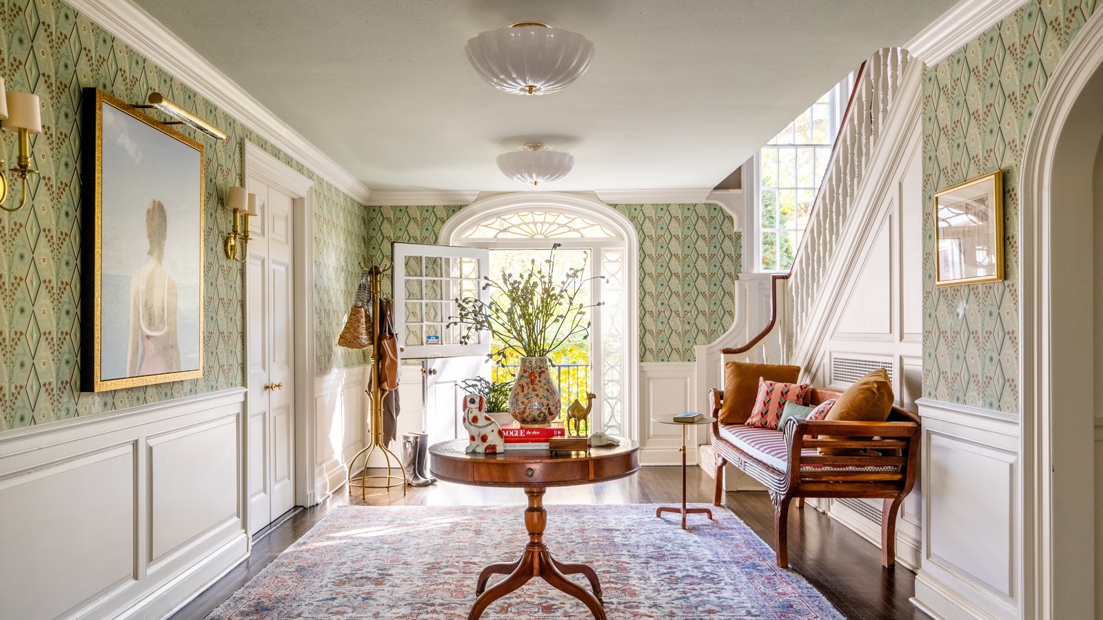Green patterned wallpaper in a bright, elegant interior